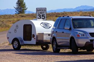  Teardrop trailer towed by a small SUV