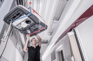 RV technician replacing a cooling system