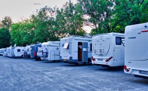  RV motorhomes lined up at a campsite