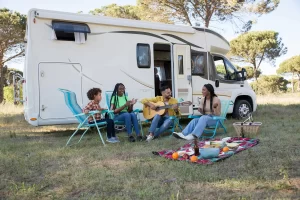 Family listening to music by their Class C RV